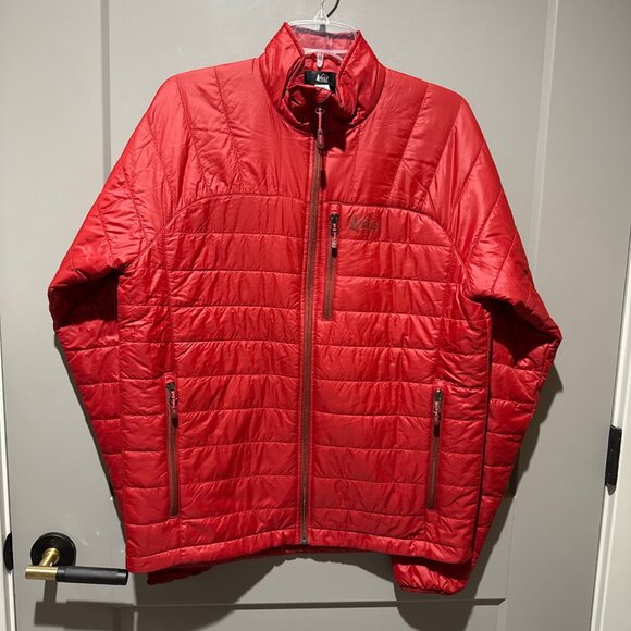 The REI Puffer Jacket in red is a stylish and versatile outerwear option for men - Picture 1 of 7